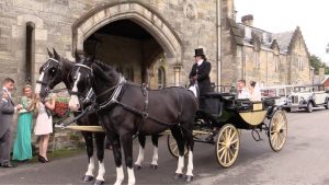 Graham and Sophie's Ashdown Park wedding in a horse drawn carriage