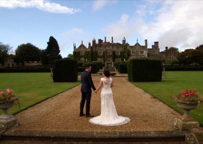 Aimee and Mike face the front on the steps of Eastwell Manor