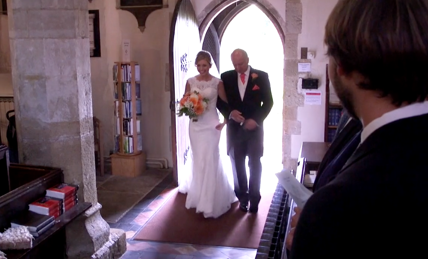 Bride entrance to the church with two camera operators